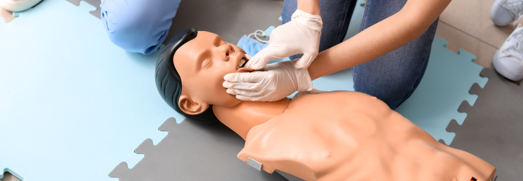 Students of Nationally Accredited HLTAID011 First Aid Course learning CPR in a doll